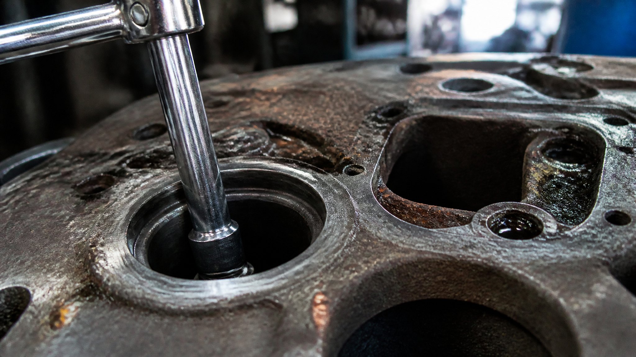 Deep socket reaching into a recessed pocket in a cast iron housing